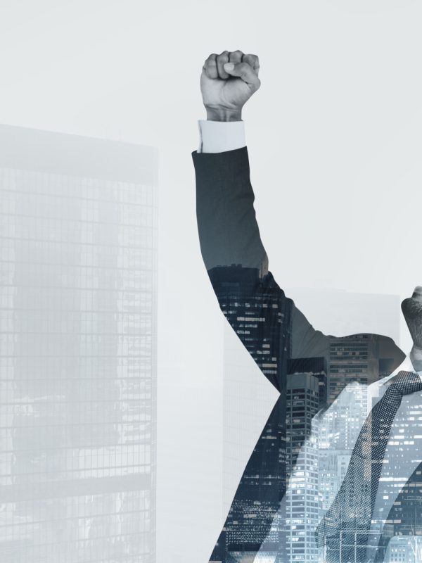 Successful businessman raising his hand in the air